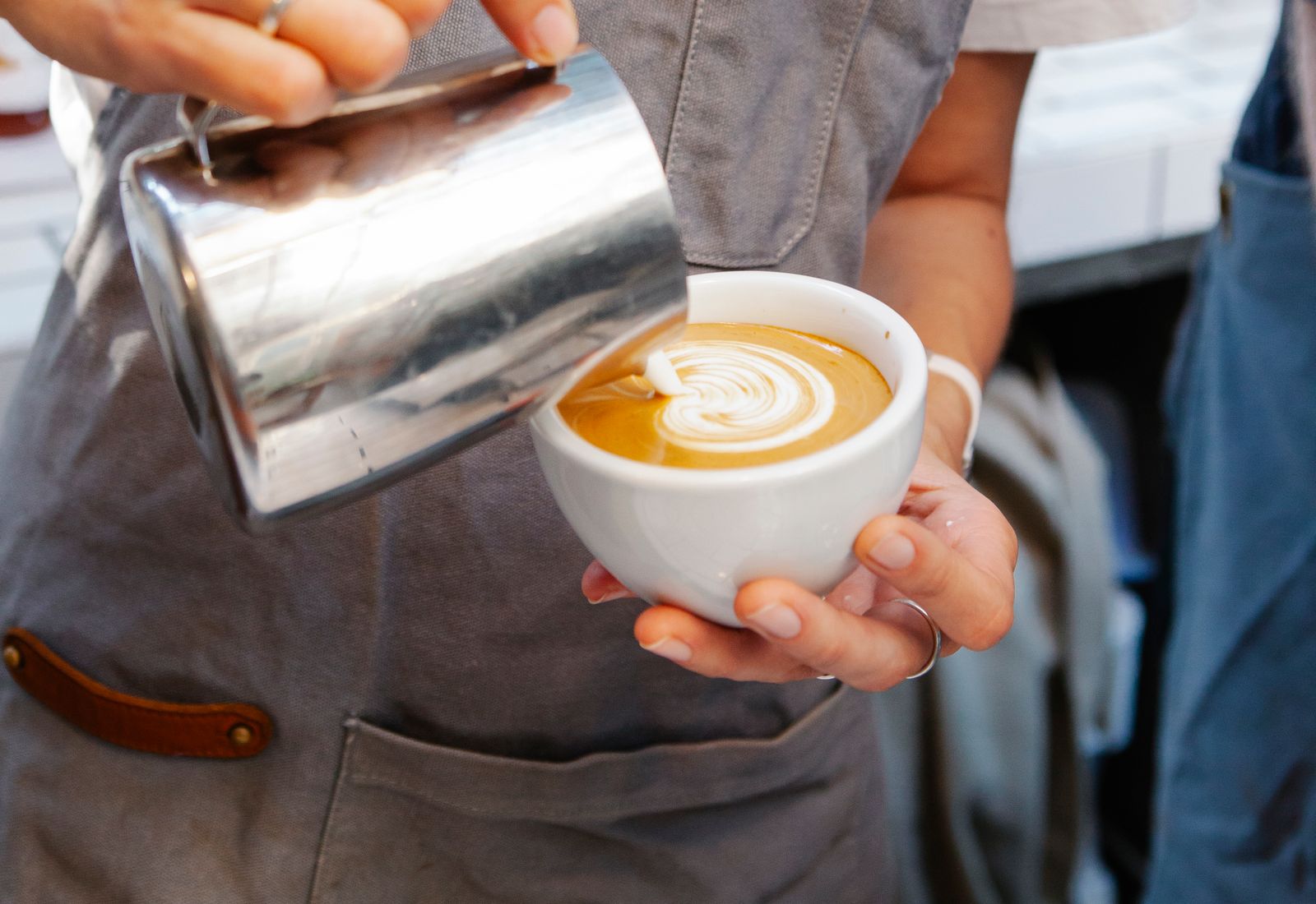 A barista carefully preparing coffee